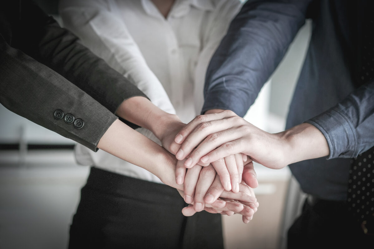 Image,Of,Businesspeople,Hands,On,Top,Of,Each,Other,As